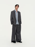 Person wearing a gray suit with a white shirt on a white background